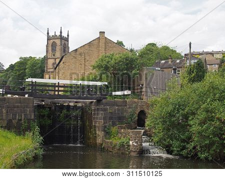 Lock Gates On The Canal In Sowerby Bridge In West Yorkshire With The Historic Christ Church Building