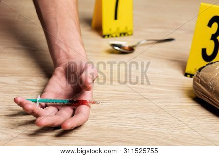 A Man Is A Drug Addict With A Syringe Using Drugs Lying On The Floor. The Concept Of Anti Drugs. Mal