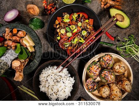 Asian food background with various ingredients on rustic stone background , top view. Vietnam and Thai cuisine.