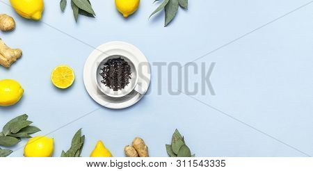 Creative Food Concept. Fresh Ginger Root, Cup Tea With Brewing Inside, Lemon, Eucalyptus Leaves On B