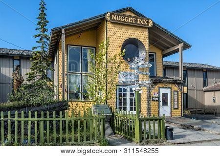 Nome, Alaska - June 10: The Historic Nugget Inn With Distance Signs To Other States And Countries As