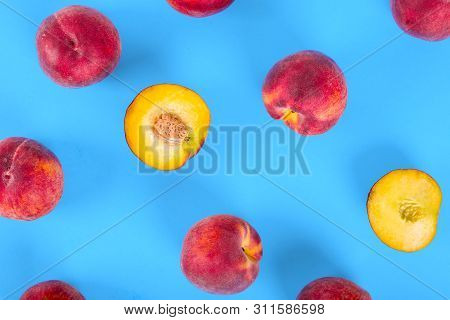 Peaches Pattern. Top View Of Fresh Fruits On A Blue Background. Repetition Concept