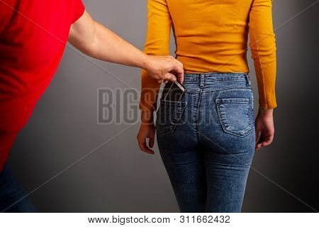The Thief Stepping Up Imperceptibly Behind The Girl Is Trying To Steal A Smartphone From The Back Po
