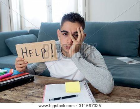 Young Desperate Student In Stress Working And Studying Holding A Help Sign.