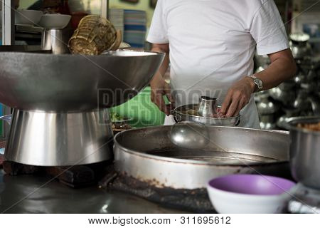 Chef Cooking A Noodle Soup At Street Food Market