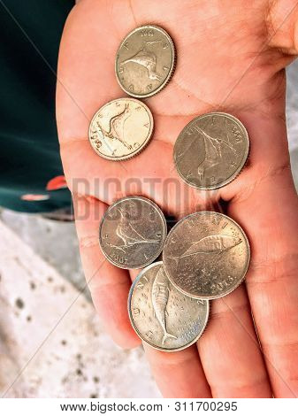 A Hand Holding Croatian Kuna Coins. The Kuna Is The Currency Of Croatia, In Use Since 1994. It Is Su