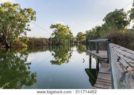 Panoramic View At The Setting Sun On The Remains Of A Wooden Pier On The Bank Of The Alexander River