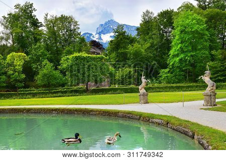Salzburg, Austria - May 25, 2019 : Sculptures Of A Unicorn In The Park On The Background Of The Moun