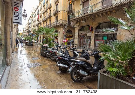 Barcelona, Spain- 09 November 2014: Carrer Dels Flassaders, Narrow, Wet Street At The Center Of The 
