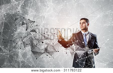 Business Person Pointing On Abstract Network Structure. Standing Personal Assistant In Business Suit