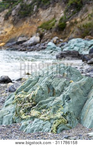 Green Mineral Rock Close Up, Gemstone Olivine Texture Common Stone On Peloponnese, Greece Close Up