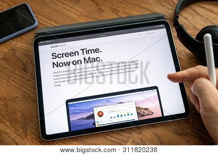 Paris, France - Jun 6, 2019: Man Reading On Apple Ipad Pro Tablet About Latest Announcement Of At Ap