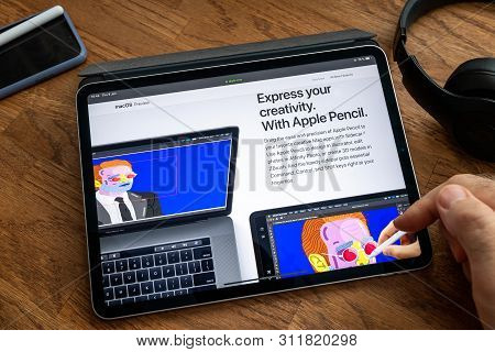 Paris, France - Jun 6, 2019: Man Reading On Apple Ipad Pro Tablet About Latest Announcement Of At Ap