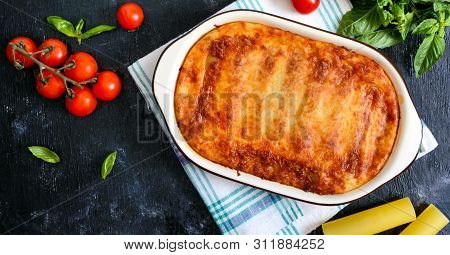 Stuffed Cannelloni With Bechamel Sauce. Cannelloni Pasta Baked With Meat, Cream Sauce, Cheese On A B
