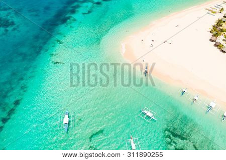 Daco Island, Philippines. Palm Trees And Bungalows On The White Sandy Beach. People Relax On A Tropi