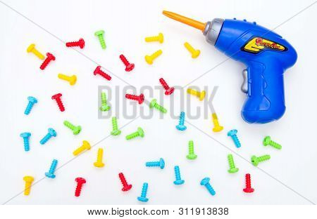 Toys Background. Top View Of Toy Tools. Screwdriver And Colored Bolts. Isolate. Kids Building Toys T