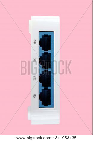 White 8 Port Plastic Ethernet Switch Isolated On Pink Background At Dry Day