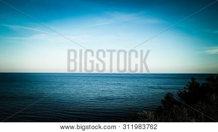 Baltic Sea From Cliff In Mechelinki, Poland. Nature And Travel Concept. Copy Space On Blue Sky.