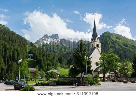 Arabba City Center, Trentino Alto-adige, Italy. Catholic Church And Beautiful Dolomites Mountains On