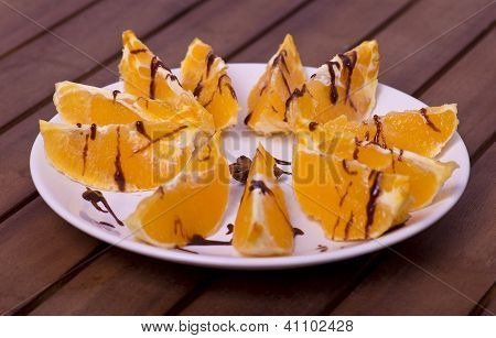 pieces of oranges on the plate with chocolate