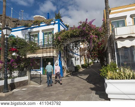 Puerto De Mogan, Gran Canaria, Canary Islands, Spain December 18, 2020: Senior Man And Woman On A Wa