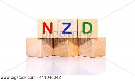 The Concept Of Nzd. Wooden Blocks With The Inscription Nzd On A White Background.