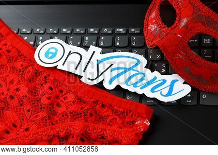 Kharkov, Ukraine - February 14, 2021: Onlyfans Paper Logo And Red Lingerie On Black Laptop Keyboard.