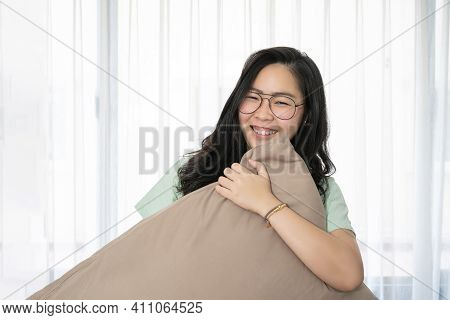 Glasses Beautiful Asian Woman Is Hugging Her Pillow And Smiling To The Camera In The Bedroom With A 