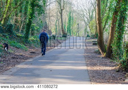 Holywell, Flintshire, Uk: Mar 2, 2021: A Lone Dog Walker On A Disused Railway Line Repurposed As An 
