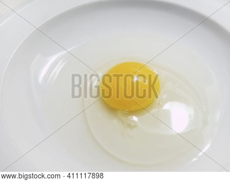 Stale Eggs With Rupture Broken Egg Yolk And Watery Egg White In A White Plate On White Background. I