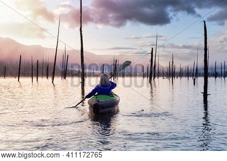 Adventurous Girl Kayaking On An Infatable Kayak In A Beautiful Lake. Colorful Peaceful Sunrise Art R