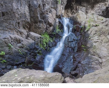Small Waterfall At Lush Landscape Of Barranco De Los Cernicalos Ravine. Long Exposure. Gran Canaria,