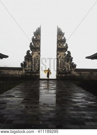 Natural Mirror Reflection Of Young Blond Woman Tourist Standing At Famous Gate Balinese Gateway To H