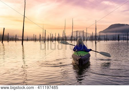 Adventurous Girl Kayaking On An Infatable Kayak In A Beautiful Lake. Colorful Peaceful Sunrise Art R