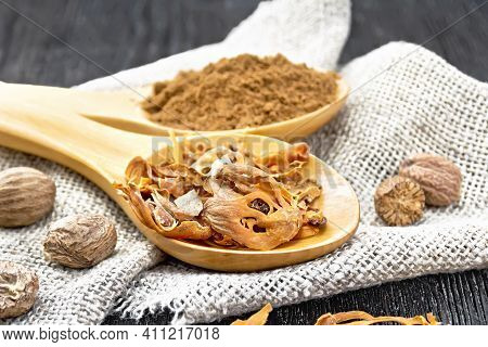 Nutmeg Round And Mace In Spoons On Wooden Board