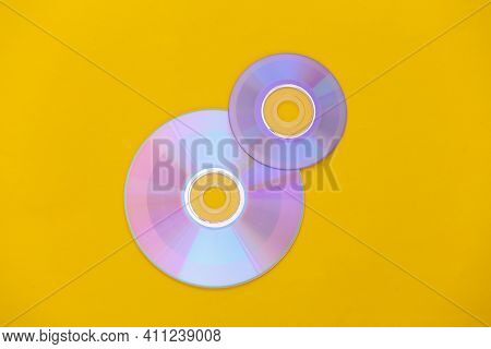 Compact Disсs On Yellow Background. Top View