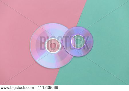 Compact Disсs On Pink Blue Pastel Background. Top View