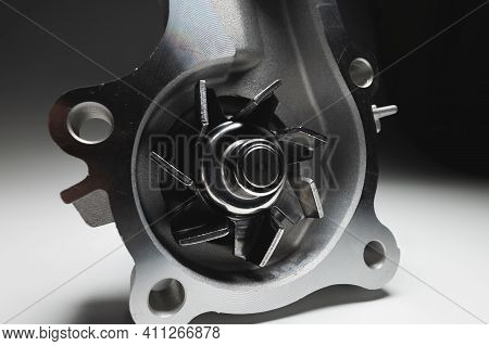 Water Pump Of The Internal Combustion Engine Cooling System. Contrasting On A Gray Gradient