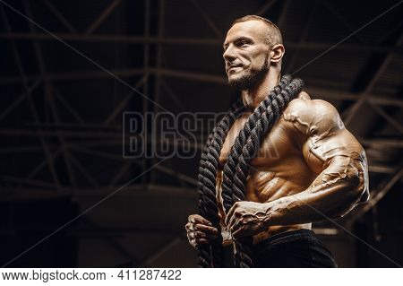Fitness Athletes Training Using Battle Ropes Intense Workout Team Exercise Challenge In Gym Enjoying