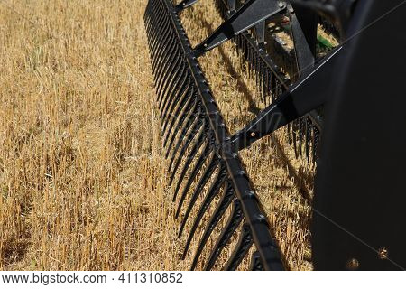 BONNYVILLE, ALBERTA, CANADA - SEPTEMBER 12, 2020: Closeup view of John Deere tines on a combine parked during harvest