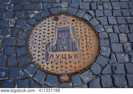 Lutsk. Ukraine. December 2020.old Sewer Hatch With Ornament And Cast In Metal Form Of Ringing On The