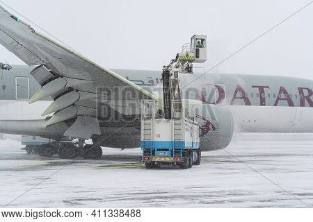Ukraine, Kyiv - February 12, 2021: De-icing The Aircraft Before The Flight. The Deicing Machine Spri