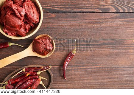 Traditional Turkish Chili Pepper Paste In Bowl Or Spoon With Dried Peppers On Wooden Table, Homemade