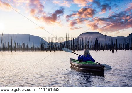 Adventurous Girl Kayaking On An Infatable Kayak In A Beautiful Lake. Colorful Peaceful Sunrise Art R