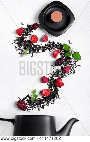 Dry Tea Leaves, Freeze Dried Strawberry, Raspberry And Blackberry And Mint Arranged In A Wave On The
