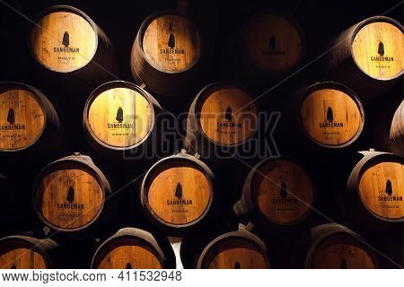 Porto, Portugal: Old Wooden Barrel Inside The Winery Sandeman, It Making Porto Wine From 18th Centur