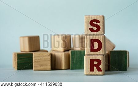 Sdr (special Drawing Rights) - Acronym On Wooden Cubes On A Background Of Colored Block On A Light B