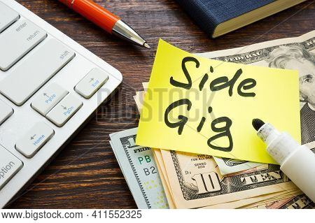 Money From Side Gig And Keyboard On The Desk.