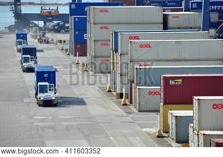 Jakarta, Indonesia - May 6, 2017: Container Trucks Passed Between Stacks Of Containers At The Port O