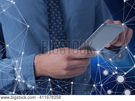 Network of connections over mid section of businessman using smartphone against blue background. global networking and business concept